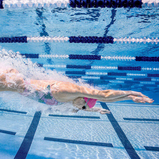 SwimOutlet image of a swimmer diving into the swimming pool.